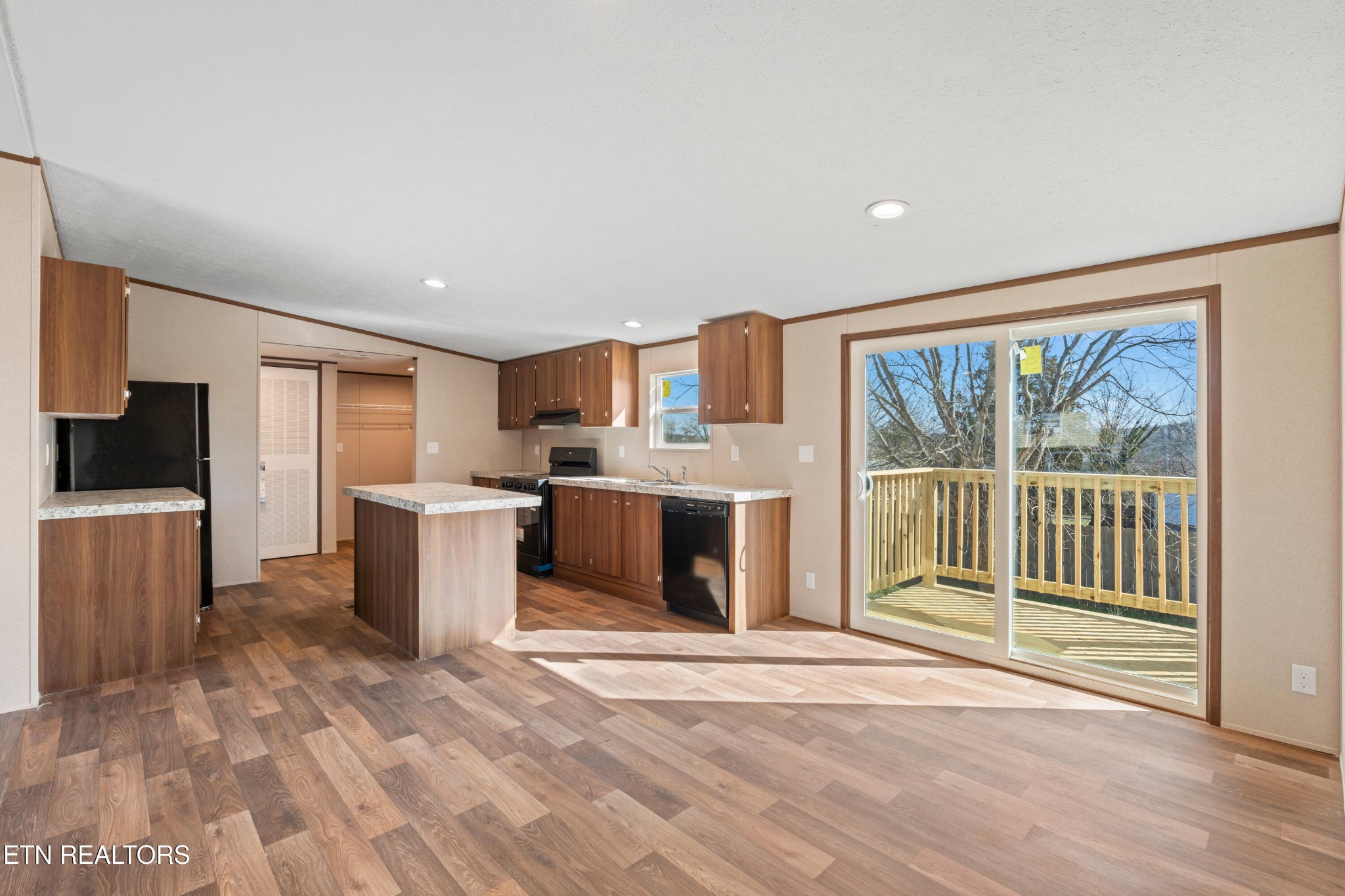 911 Summer Street Loudon, TN 37774 - Photo 2 of 25 a view of a kitchen with a sink cabinets and a floor to ceiling window