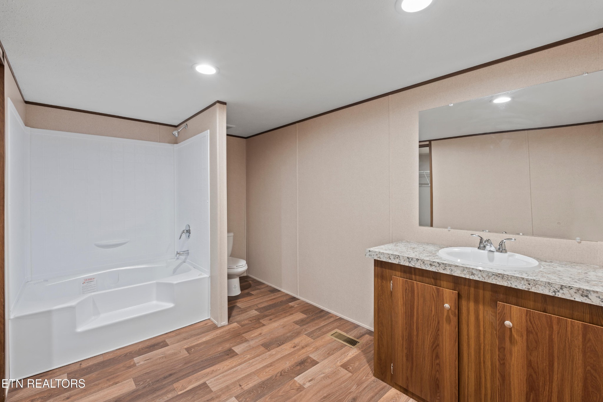 911 Summer Street Loudon, TN 37774 - Photo 5 of 25 a bathroom with a granite countertop sink and a mirror