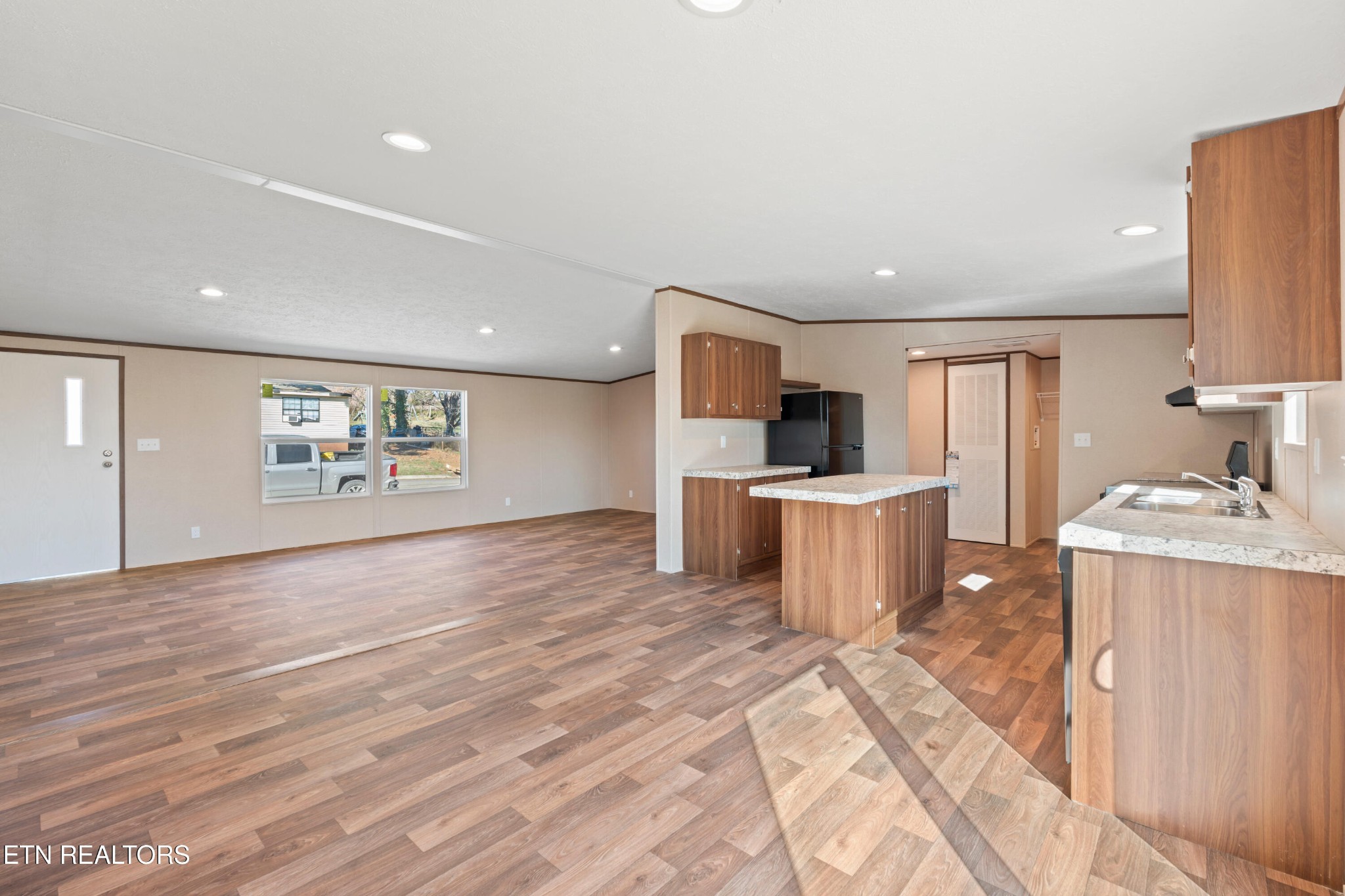 911 Summer Street Loudon, TN 37774 - Photo 8 of 25 a kitchen with stainless steel appliances kitchen island granite countertop a refrigerator a stove top oven a sink and dishwasher