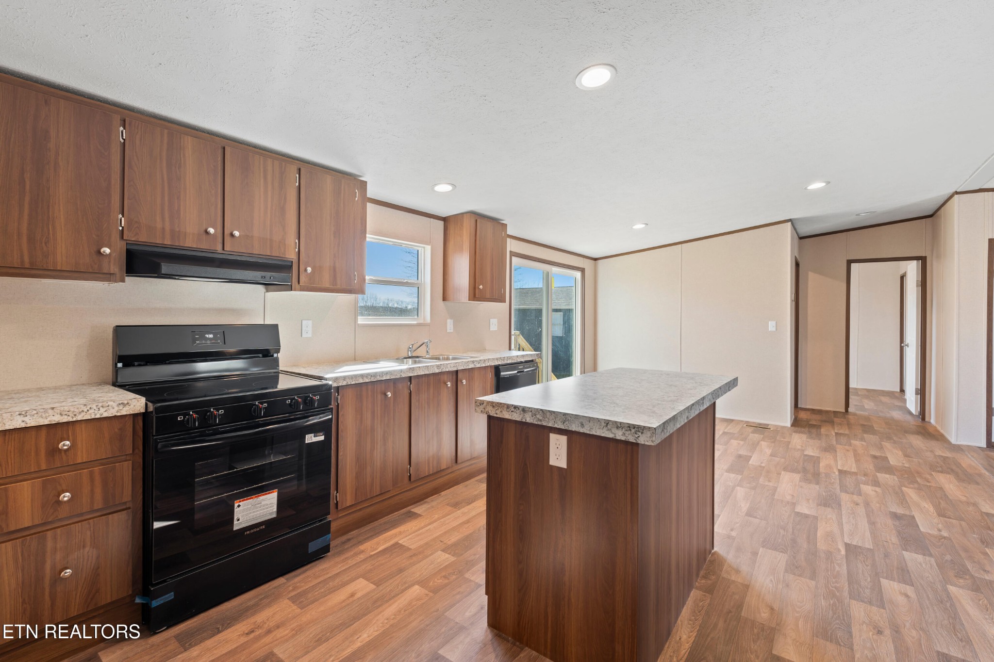 911 Summer Street Loudon, TN 37774 - Photo 9 of 25 a kitchen with a stove a sink and a refrigerator