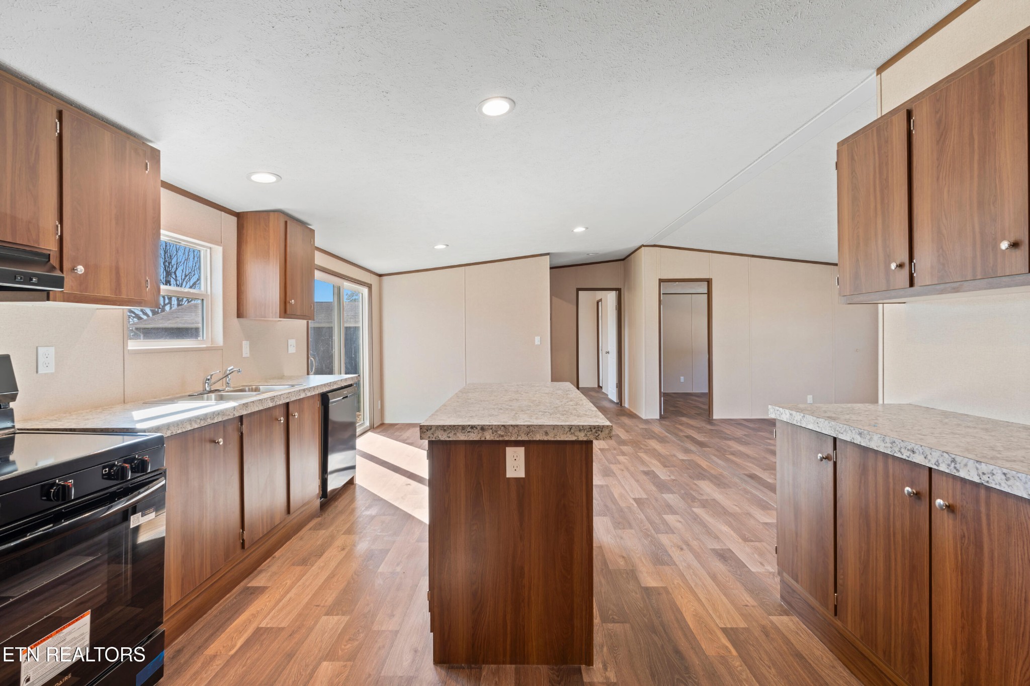 911 Summer Street Loudon, TN 37774 - Photo 10 of 25 a kitchen with stainless steel appliances granite countertop a stove a sink dishwasher and a refrigerator with wooden floor