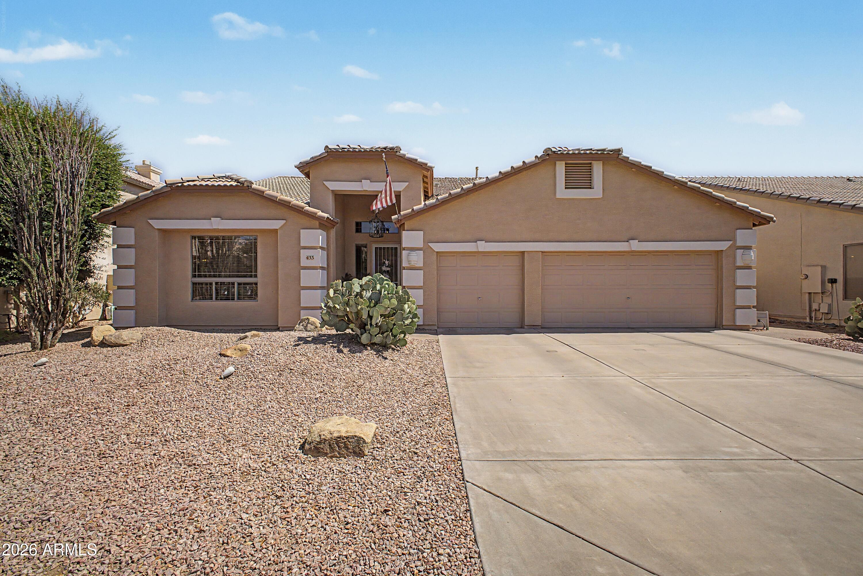 433 West Desert Avenue Gilbert, AZ 85233 - Photo 1 of 23 a front view of a house with a yard and garage