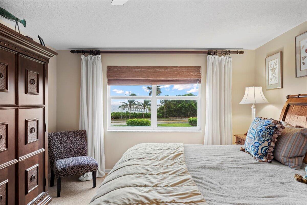 4161 U.S. Highway 1, Unit N3 Jupiter, FL 33477 - Photo 15 of 43 a bedroom with a bed and a large window