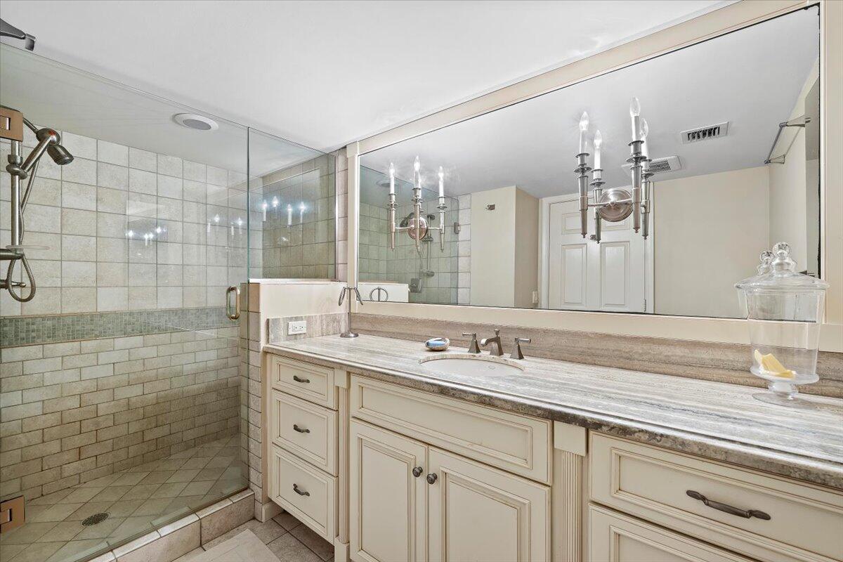 4161 U.S. Highway 1, Unit N3 Jupiter, FL 33477 - Photo 18 of 43 a bathroom with a granite countertop sink mirror and double