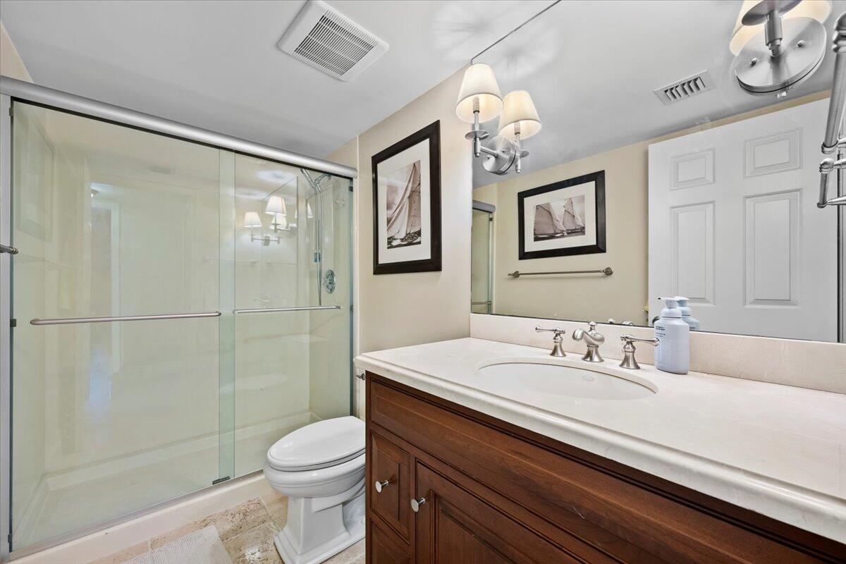 4161 U.S. Highway 1, Unit N3 Jupiter, FL 33477 - Photo 20 of 43 a bathroom with a sink a toilet and shower