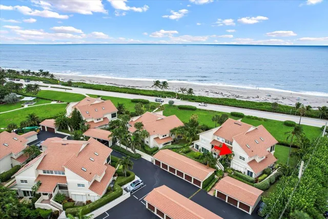 an aerial view of a house with a garden and lake view