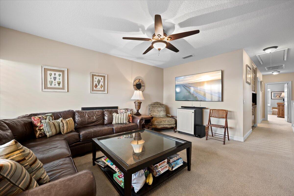 4161 U.S. Highway 1, Unit N3 Jupiter, FL 33477 - Photo 24 of 43 a living room with furniture and a flat screen tv