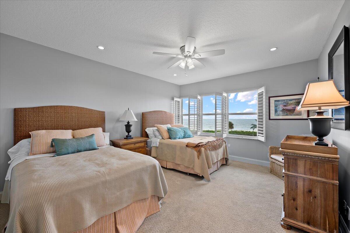 4161 U.S. Highway 1, Unit N3 Jupiter, FL 33477 - Photo 25 of 43 a bedroom with two beds and a lamp