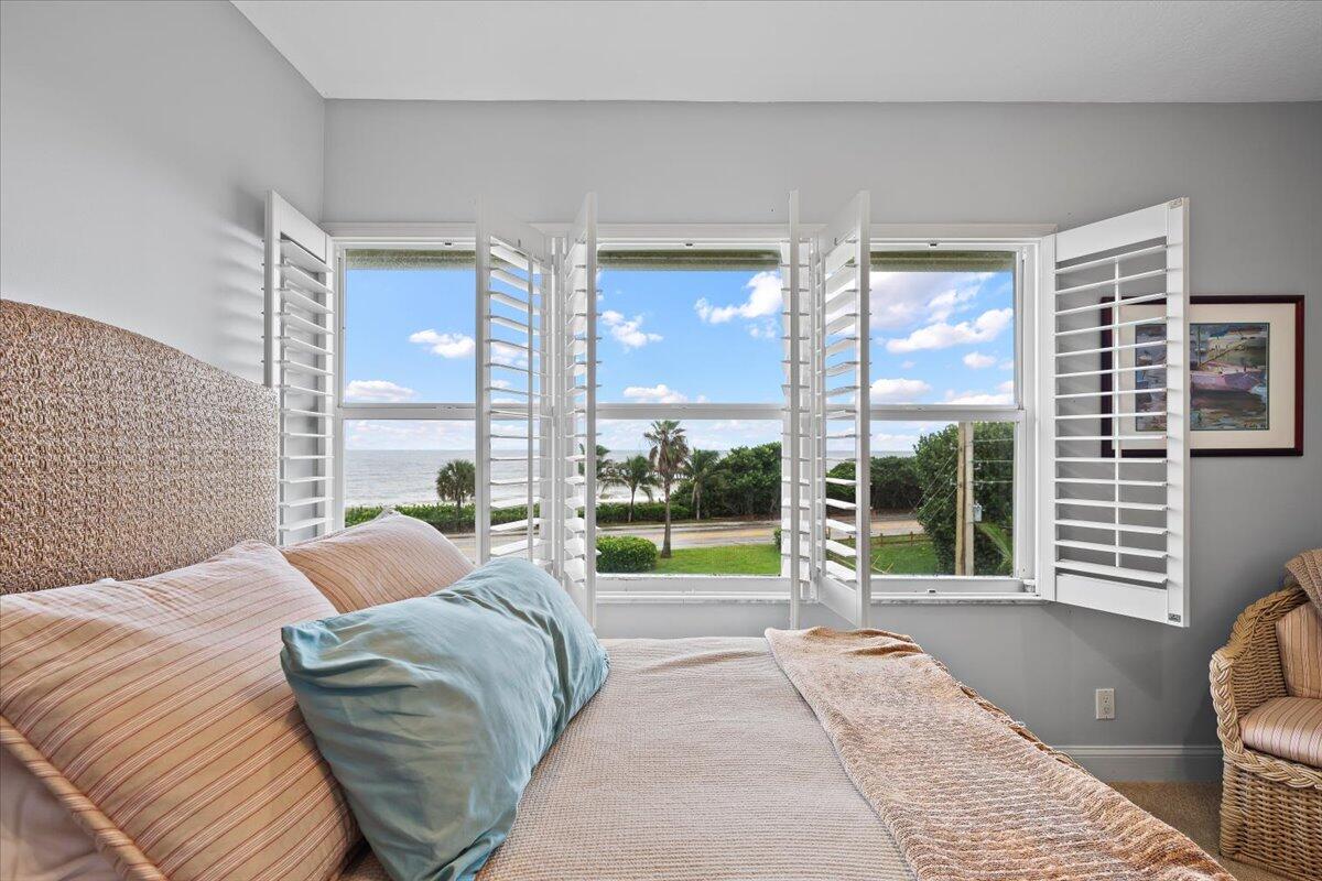 4161 U.S. Highway 1, Unit N3 Jupiter, FL 33477 - Photo 26 of 43 a bedroom with a bed and glass window