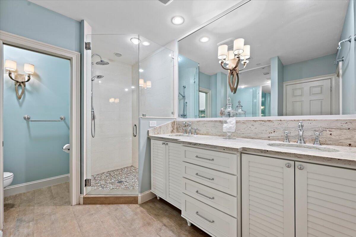 4161 U.S. Highway 1, Unit N3 Jupiter, FL 33477 - Photo 27 of 43 a bathroom with a sink mirror and a shower