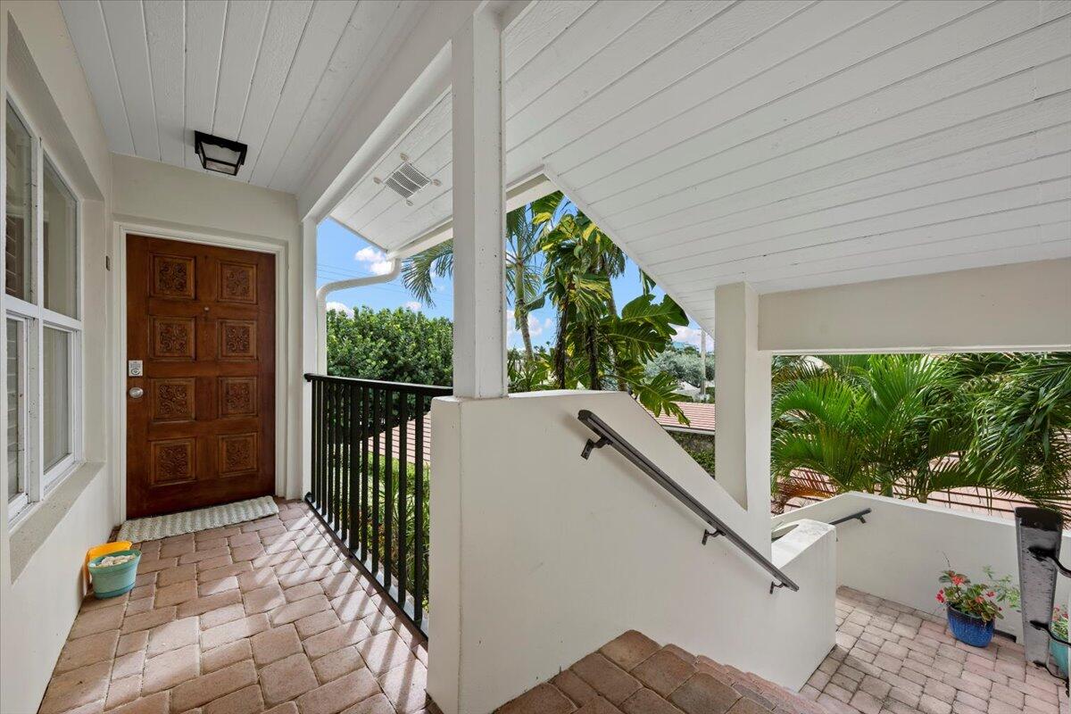4161 U.S. Highway 1, Unit N3 Jupiter, FL 33477 - Photo 3 of 43 a view of a porch with furniture and garden