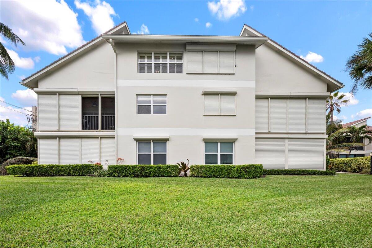 4161 U.S. Highway 1, Unit N3 Jupiter, FL 33477 - Photo 32 of 43 a front view of a house with a garden