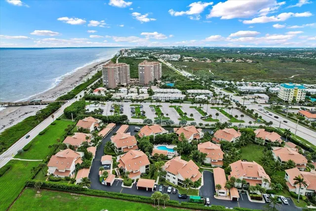 an aerial view of a house with outdoor space and lake view in back