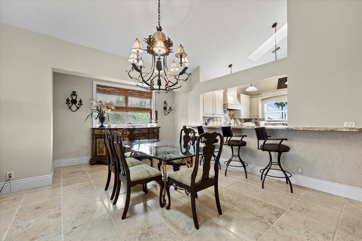 4161 U.S. Highway 1, Unit N3 Jupiter, FL 33477 - Photo 7 of 43 a view of a dining room with furniture and chandelier