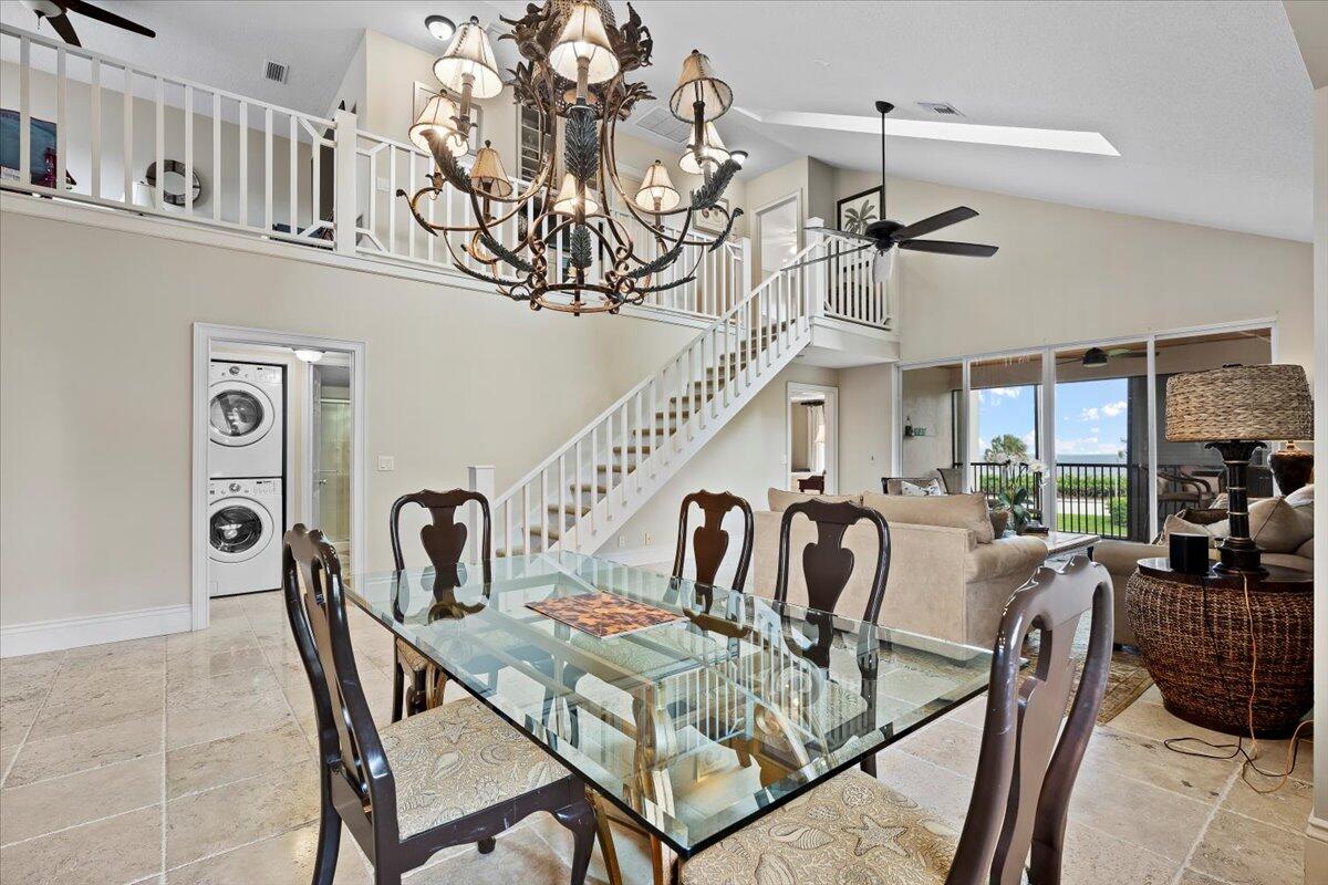 4161 U.S. Highway 1, Unit N3 Jupiter, FL 33477 - Photo 9 of 43 a view of a dining room with furniture wooden floor and chandelier