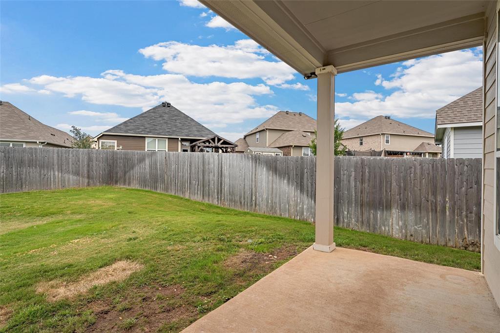 3205 Dottavio Road Lorena, TX 76655 - Photo 29 of 33 Covered concrete patio overlooking a fenced backyard with a grassy area