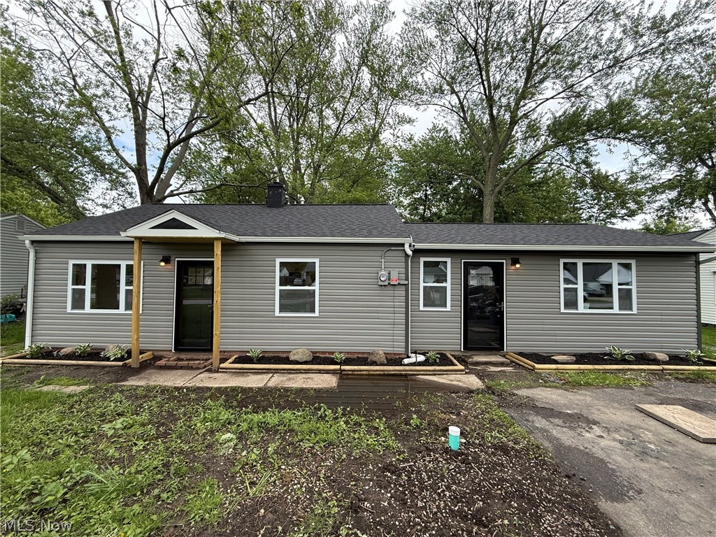Gray horizontal siding exterior with a dark shingle roof