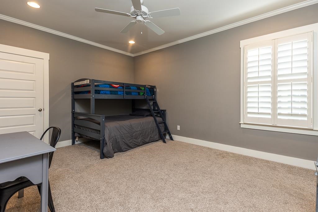 328 Washington Street Collierville, TN 38017 - Photo 23 of 33 Carpeted room featuring a ceiling fan with integrated lighting, recessed overhead lighting, and white crown molding