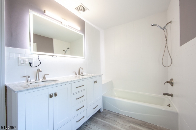 16 Columbus Avenue Glen Ridge, NJ 07028 - Photo 9 of 14 a bathroom with a granite countertop sink a toilet and shower