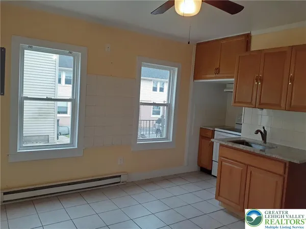 a kitchen with a sink cabinets and window
