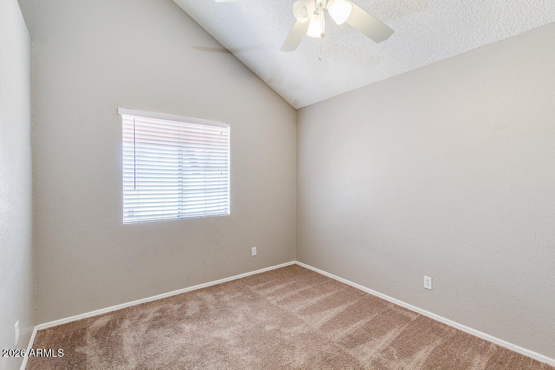 2145 East Center Lane, Unit 2 Tempe, AZ 85281 - Photo 12 of 20 an empty room with a chandelier fan