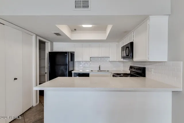 a kitchen with stainless steel appliances a refrigerator sink stove microwave and cabinets