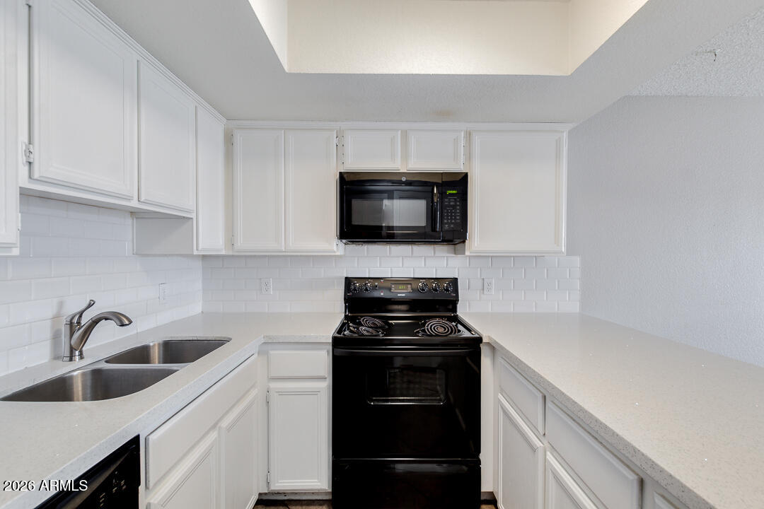 2145 East Center Lane, Unit 2 Tempe, AZ 85281 - Photo 5 of 20 a kitchen with a sink and cabinets