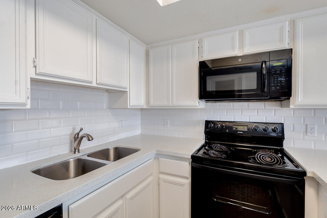 2145 East Center Lane, Unit 2 Tempe, AZ 85281 - Photo 6 of 20 a kitchen with microwave a stove and cabinets