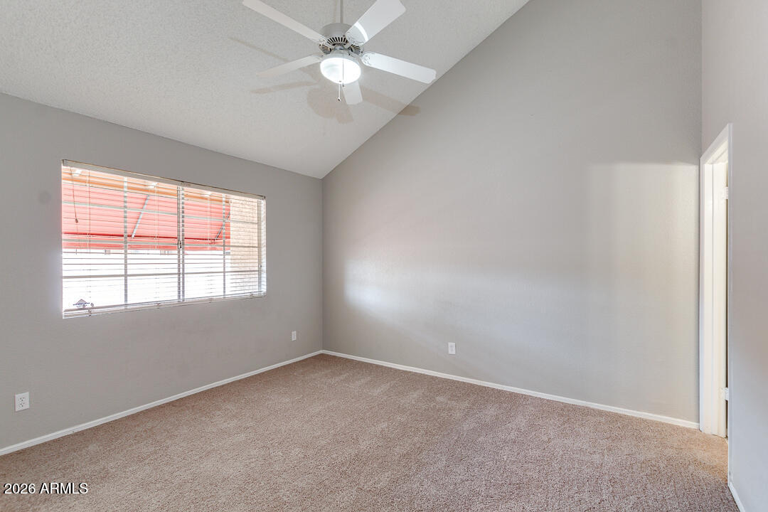 2145 East Center Lane, Unit 2 Tempe, AZ 85281 - Photo 7 of 20 an empty room with a window and a fan