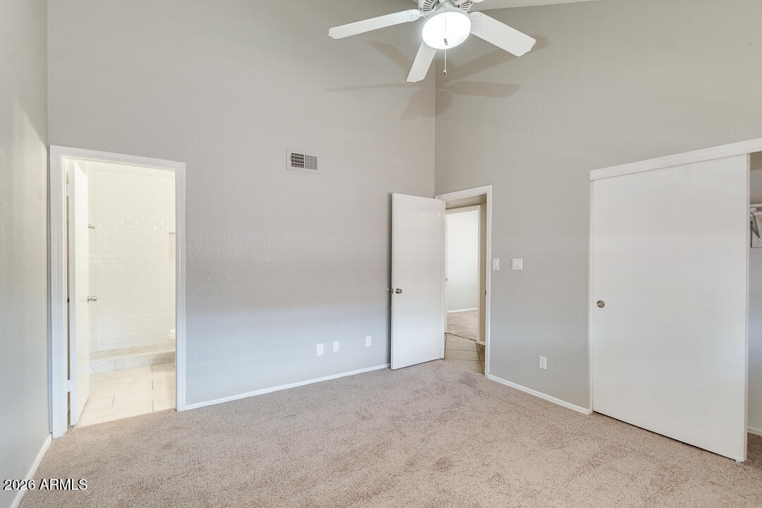 2145 East Center Lane, Unit 2 Tempe, AZ 85281 - Photo 9 of 20 an empty room with a chandelier fan