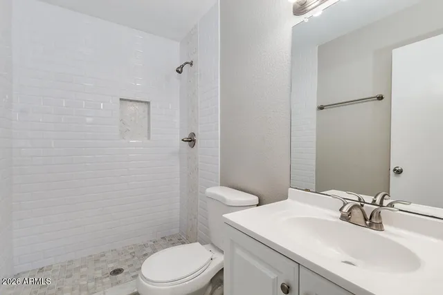 a bathroom with a sink toilet and shower