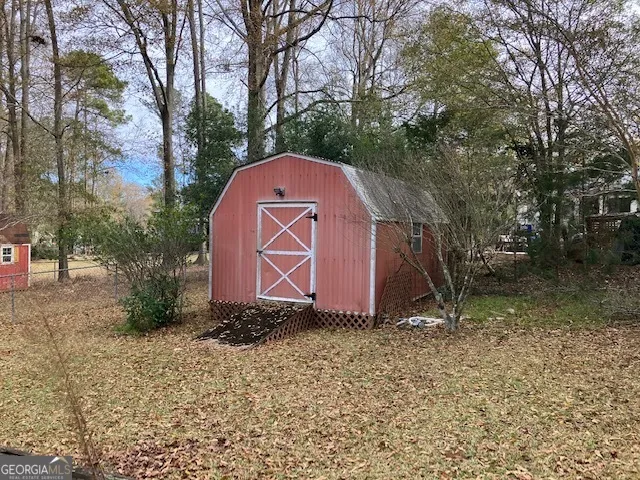 a area with trees and a wooden fence