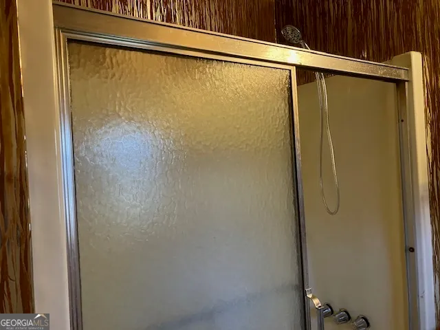 a bathroom with a glass shower door