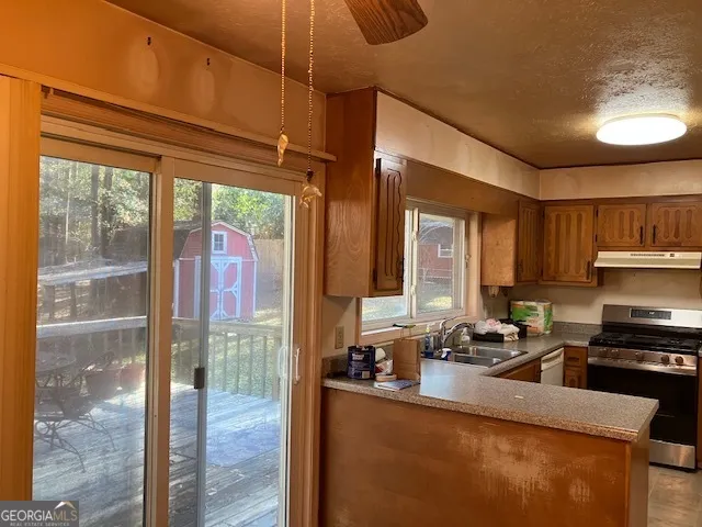 a kitchen with sink a refrigerator and cabinets