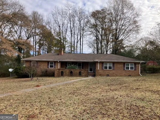 a house that has a tree in front of it