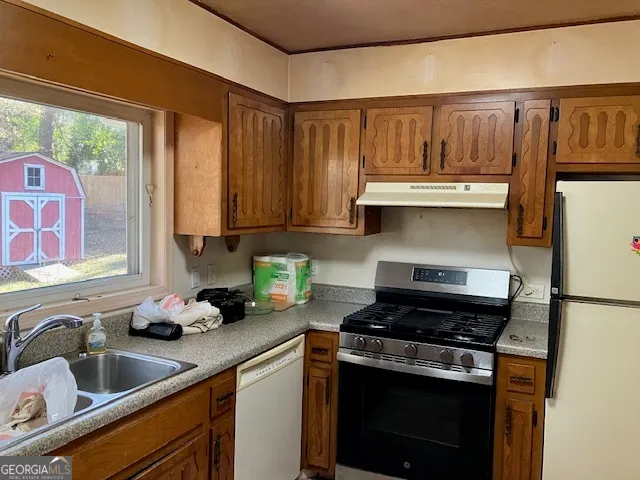 a kitchen with stainless steel appliances granite countertop a sink stove and cabinets