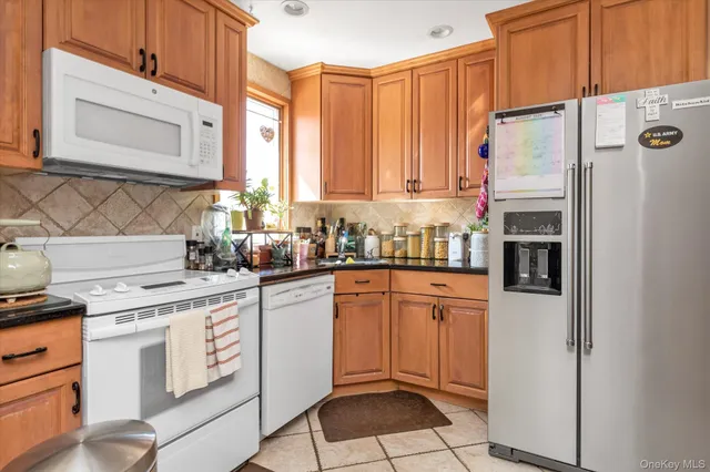 a kitchen with stainless steel appliances a refrigerator sink and cabinets