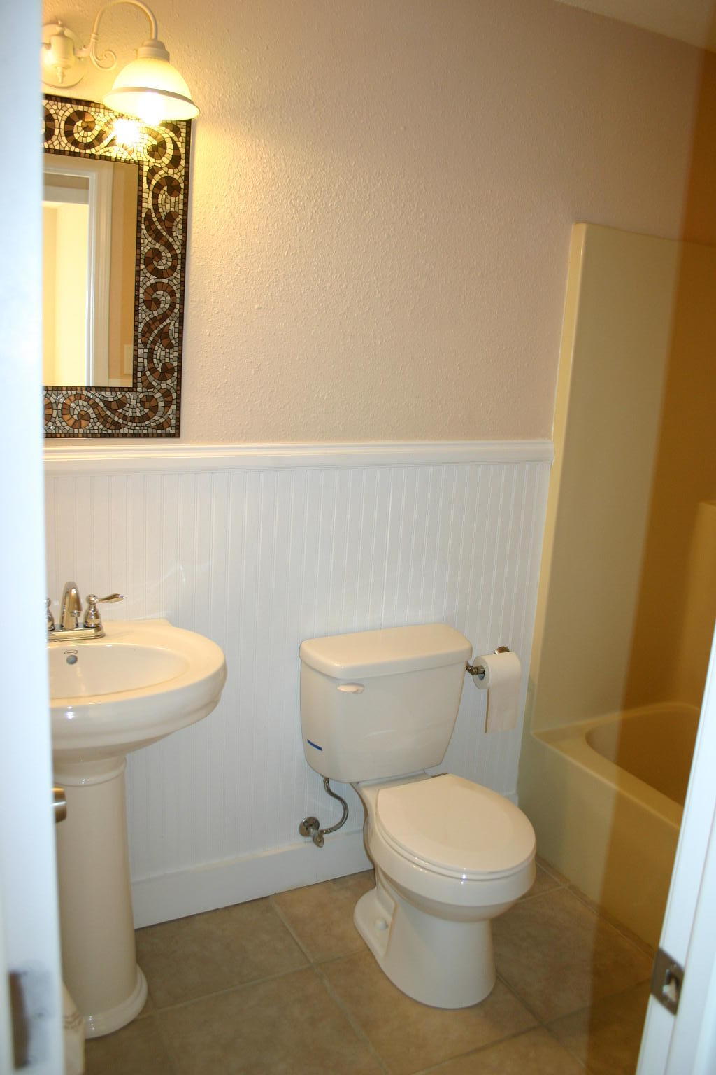 168 Ridge Lake Road Crestview, FL 32536 - Photo 12 of 28 a bathroom with a toilet sink and mirror