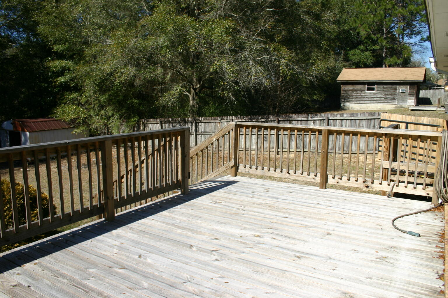 168 Ridge Lake Road Crestview, FL 32536 - Photo 25 of 28 a view of a balcony with wooden floor and fence