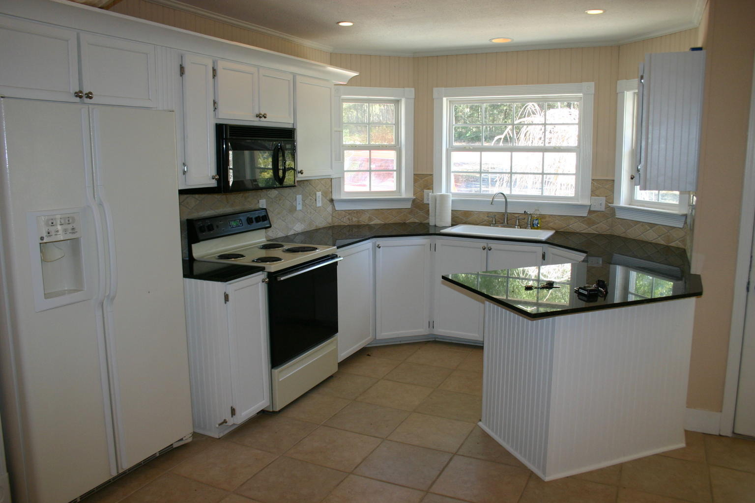 168 Ridge Lake Road Crestview, FL 32536 - Photo 3 of 28 a kitchen with granite countertop a sink stove and cabinets