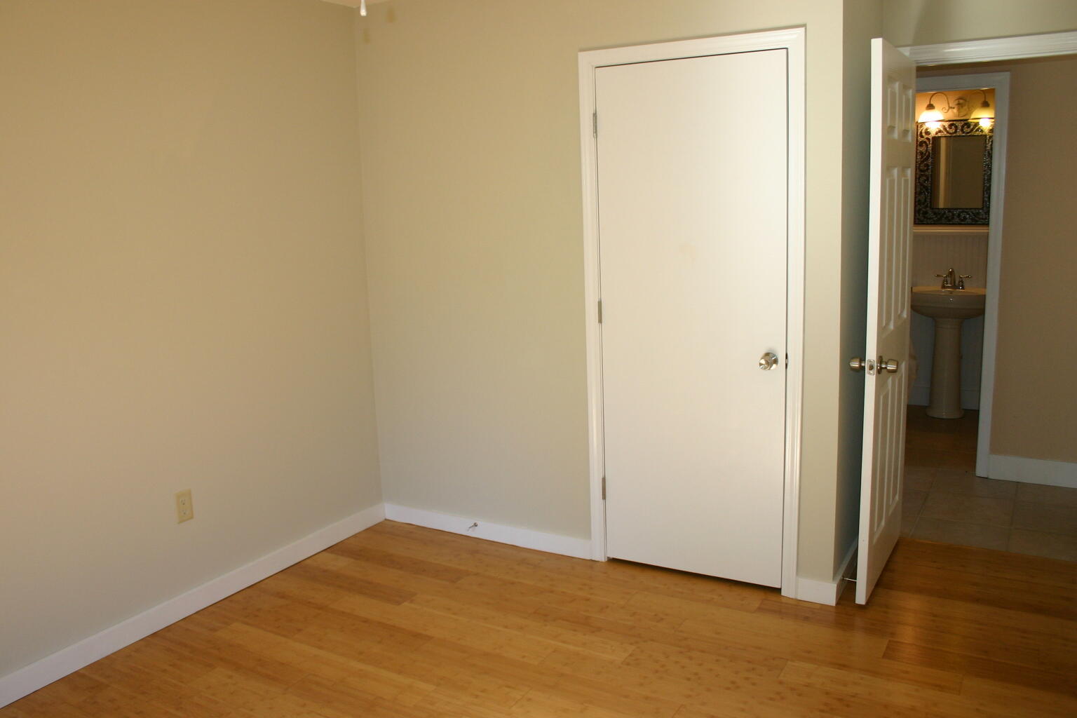 168 Ridge Lake Road Crestview, FL 32536 - Photo 9 of 28 a view of an empty room with wooden floor and a bathroom