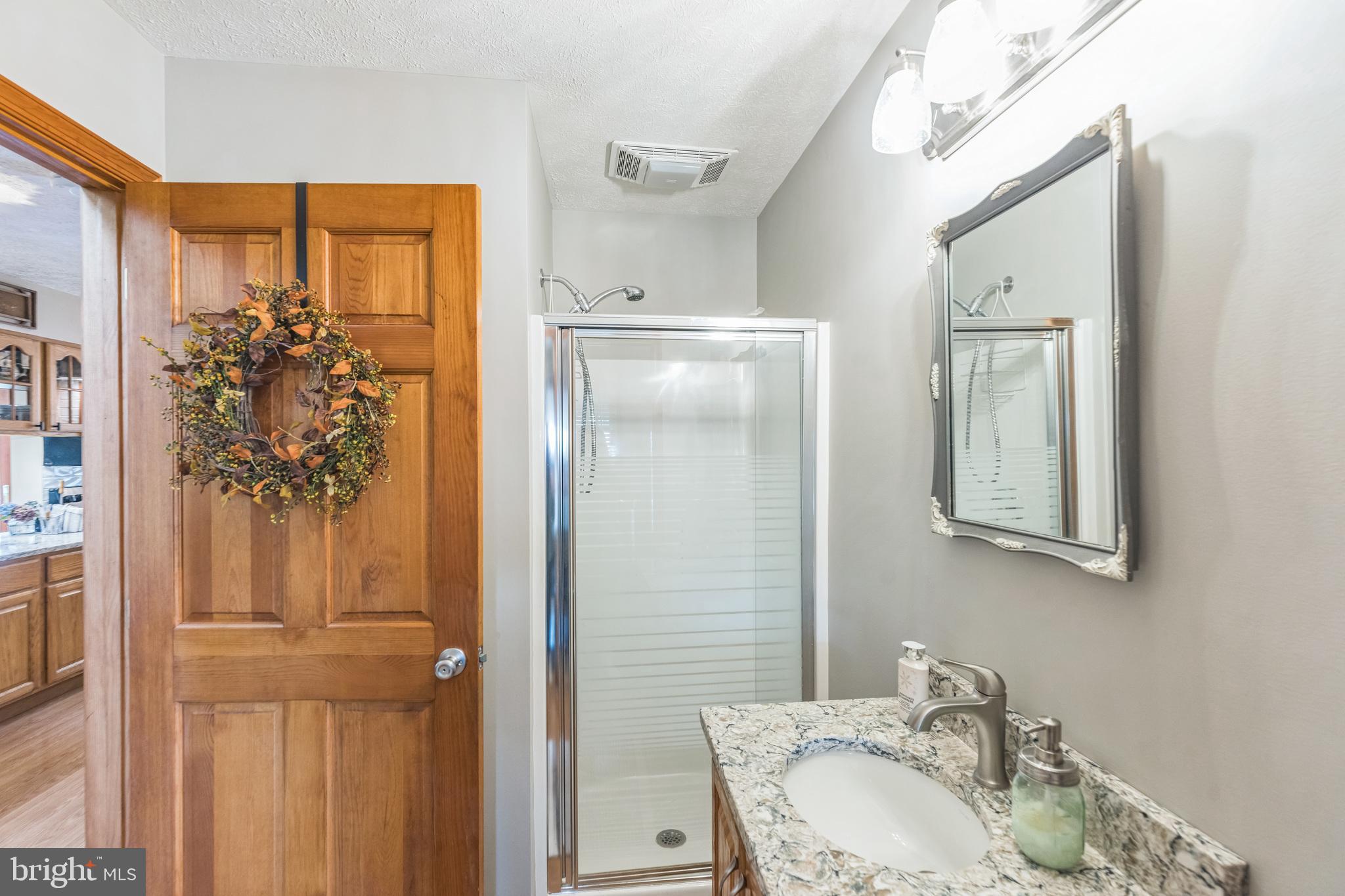 2734 Old Fort Schoolhouse Road Westminster, MD 21157 - Photo 14 of 44 a bathroom with a granite countertop sink and a mirror