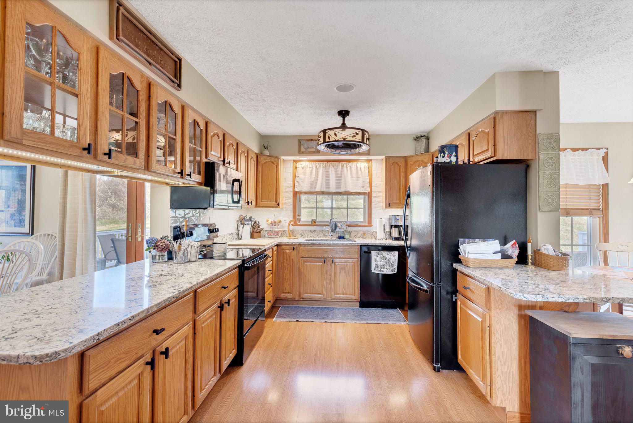 2734 Old Fort Schoolhouse Road Westminster, MD 21157 - Photo 16 of 44 a kitchen with stainless steel appliances granite countertop sink stove top oven and refrigerator