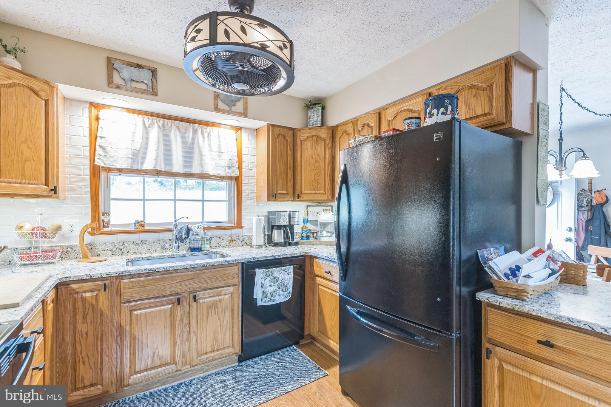 2734 Old Fort Schoolhouse Road Westminster, MD 21157 - Photo 17 of 44 a kitchen with stainless steel appliances granite countertop a refrigerator a stove and a sink
