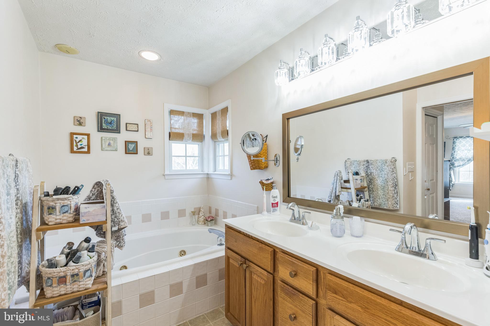 2734 Old Fort Schoolhouse Road Westminster, MD 21157 - Photo 22 of 44 a bathroom with a double vanity sink mirror and