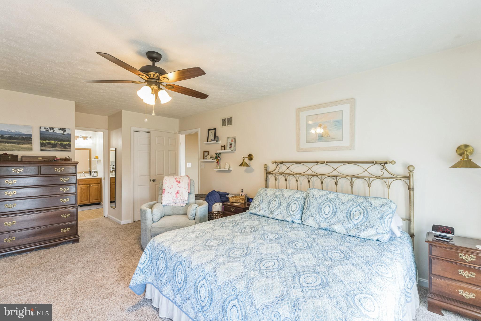 2734 Old Fort Schoolhouse Road Westminster, MD 21157 - Photo 25 of 44 a bedroom with a bed and a chandelier