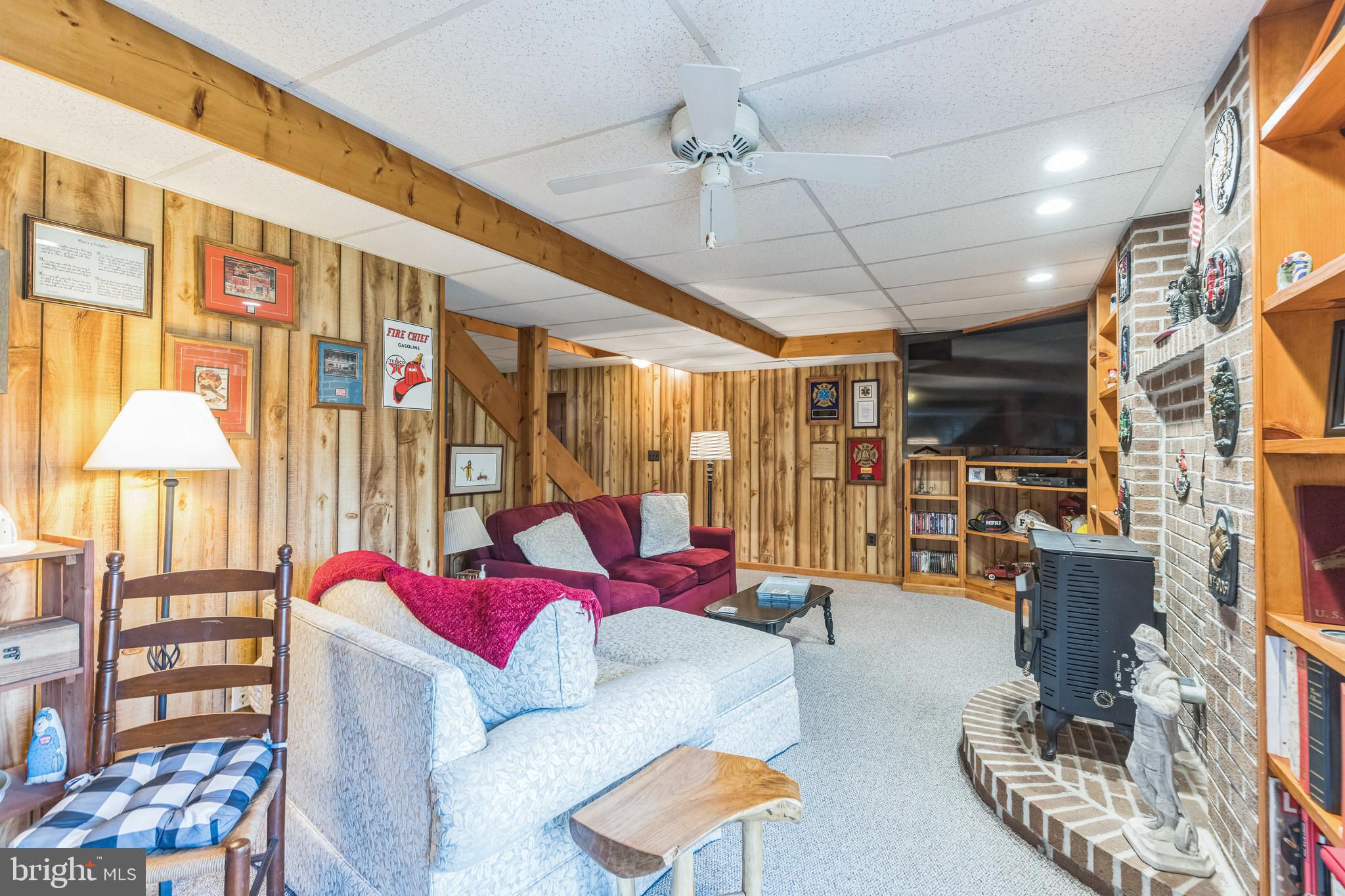 2734 Old Fort Schoolhouse Road Westminster, MD 21157 - Photo 39 of 44 a living room with furniture a flat screen tv and floor to ceiling window