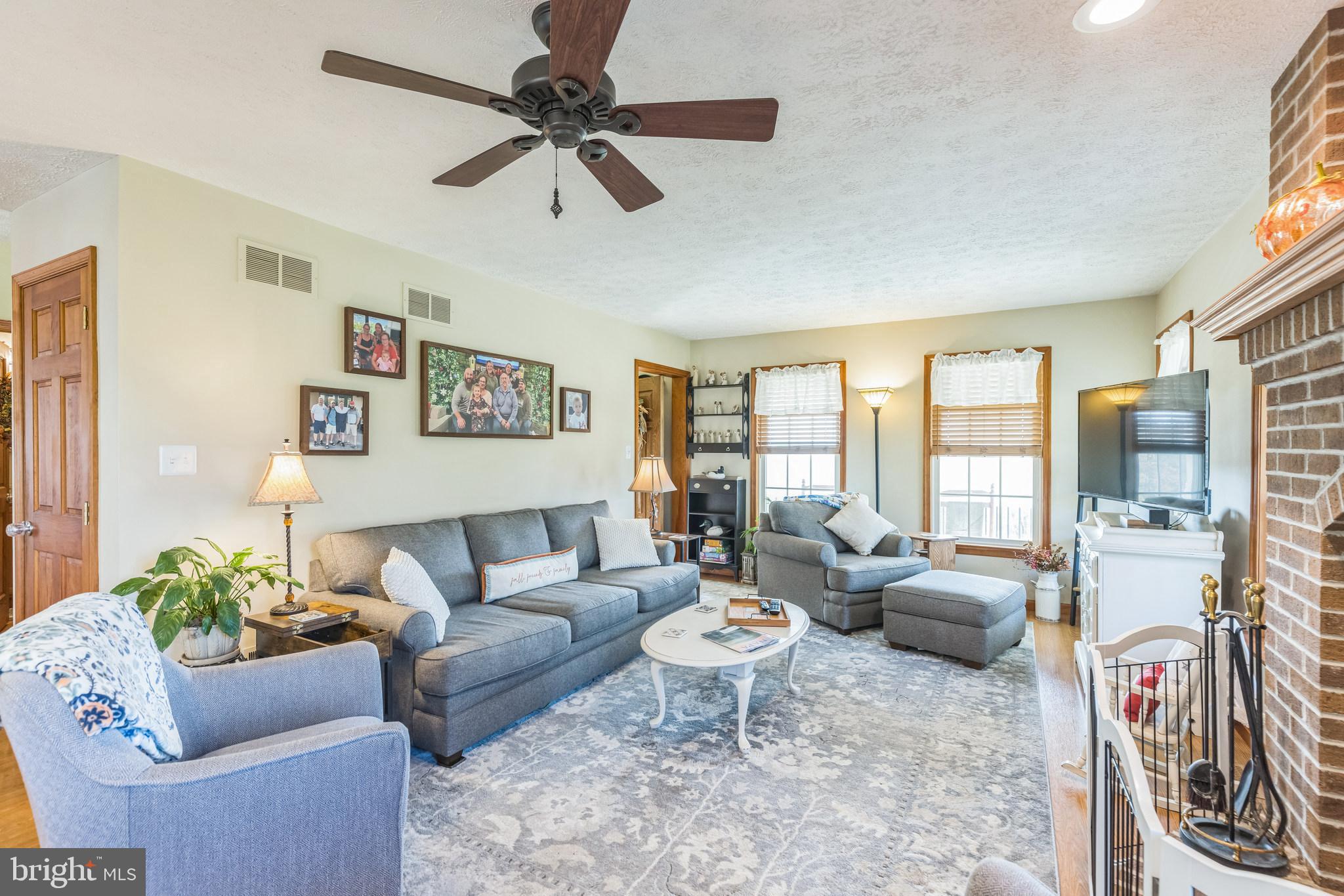 2734 Old Fort Schoolhouse Road Westminster, MD 21157 - Photo 6 of 44 a living room with furniture ceiling fan and a rug