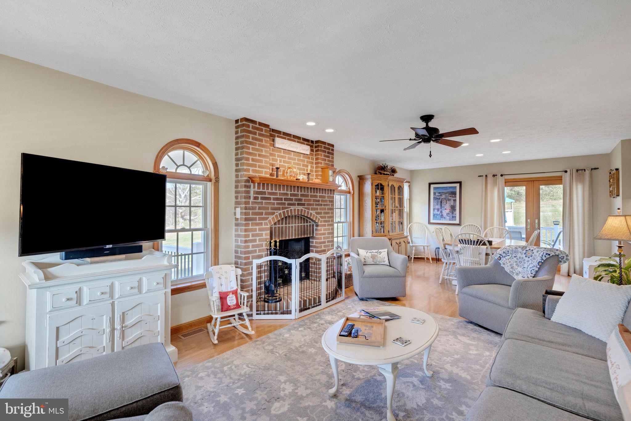 2734 Old Fort Schoolhouse Road Westminster, MD 21157 - Photo 7 of 44 a living room with furniture a flat screen tv and a fireplace