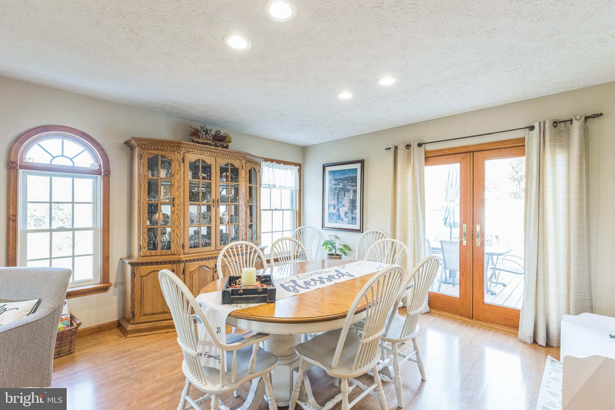2734 Old Fort Schoolhouse Road Westminster, MD 21157 - Photo 10 of 44 a view of a dining room with furniture large windows and wooden floor